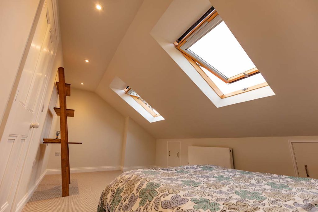 Loft bedroom with twin Velux rooflights and eaves storage in a Bishopston dormer conversion