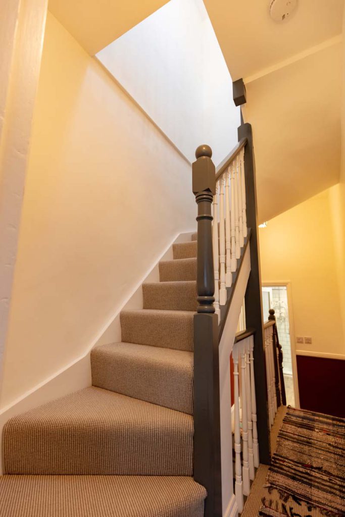 Carpeted staircase to the new loft rooms in a Bishopston dormer conversion