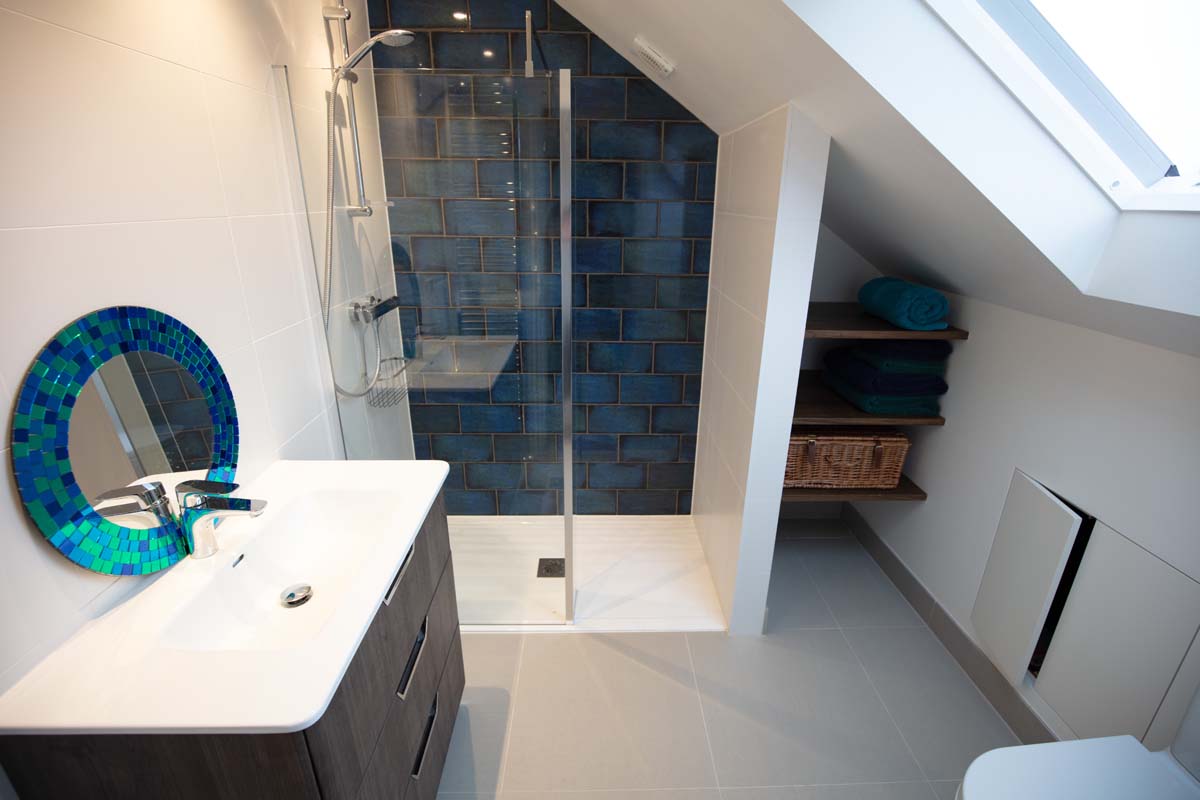 High-spec en-suite shower room with blue metro tiles and a walk-in shower in a dormer loft conversion in Horfield, Bristol