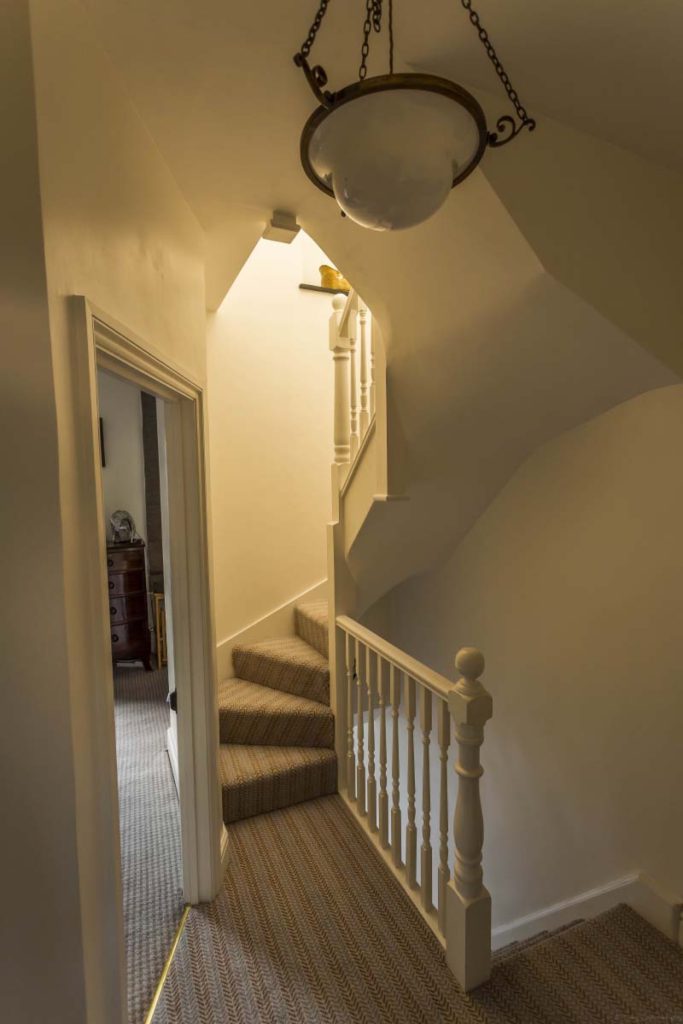 Landing and staircase with a period pendant light in a dormer loft conversion in St Werburgh's, Bristol