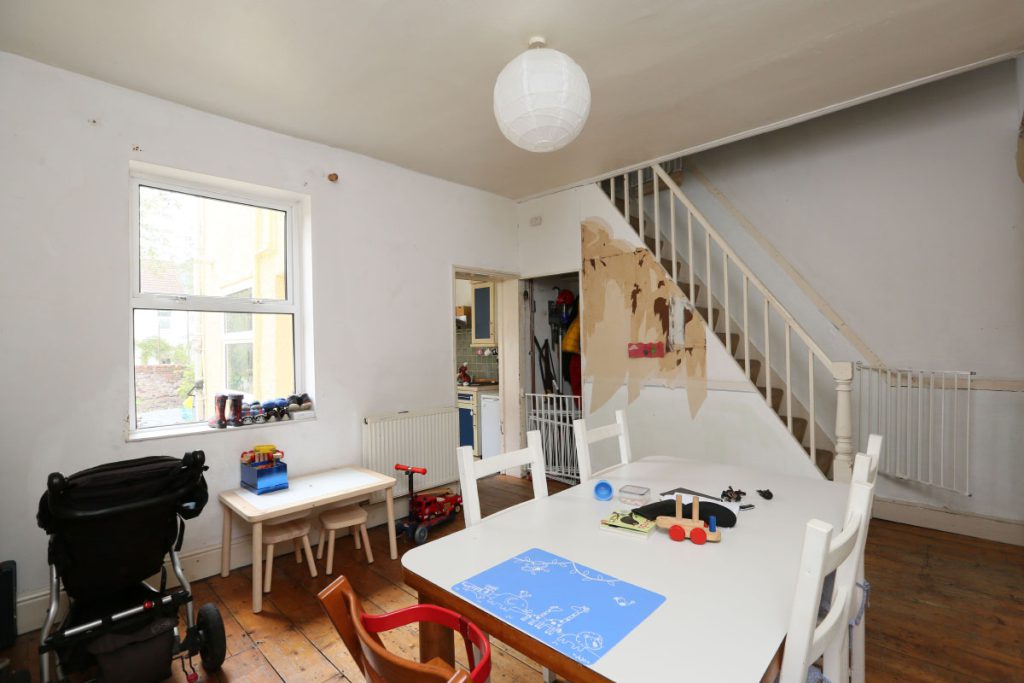 Dining room and original staircase before the refurbishment in an Easton terrace, Bristol