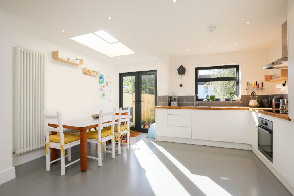 Bright kitchen-diner with a rooflight and French doors to the garden in an Easton house refurbishment, Bristol