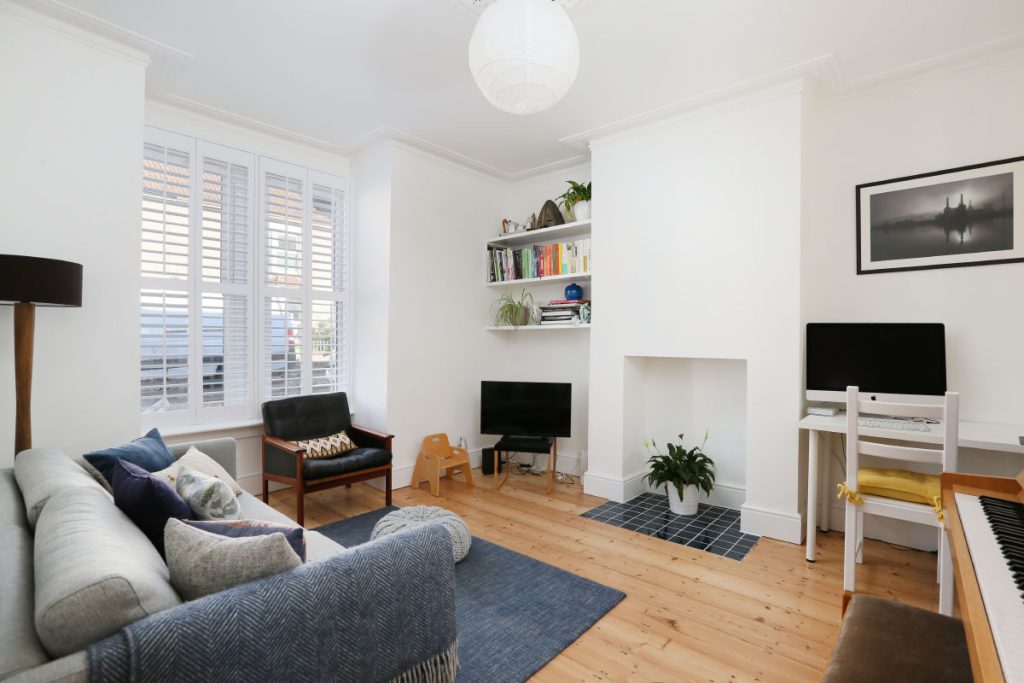 Front living room with plantation shutters and restored floorboards after a full house refurbishment in Easton, Bristol