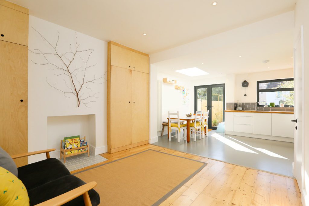 Open-plan living, kitchen and dining space with bespoke plywood storage after a full house refurbishment in Easton, Bristol