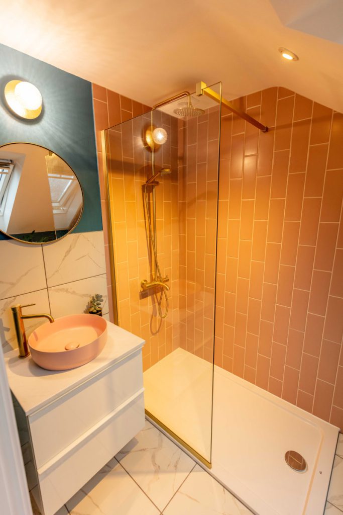 En-suite walk-in shower with terracotta tiles and brushed-gold fittings in a Bedminster dormer loft conversion