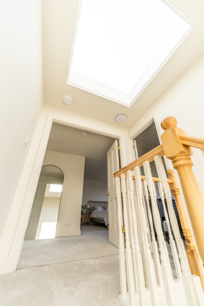 Landing beneath a large skylight in a hip-to-gable loft conversion in Bishopston, Bristol