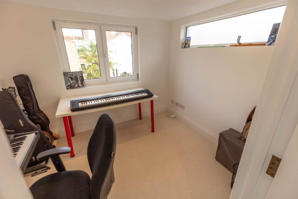 Music room with keyboard and guitars built over the rear annex of a Bedminster loft conversion, Bristol