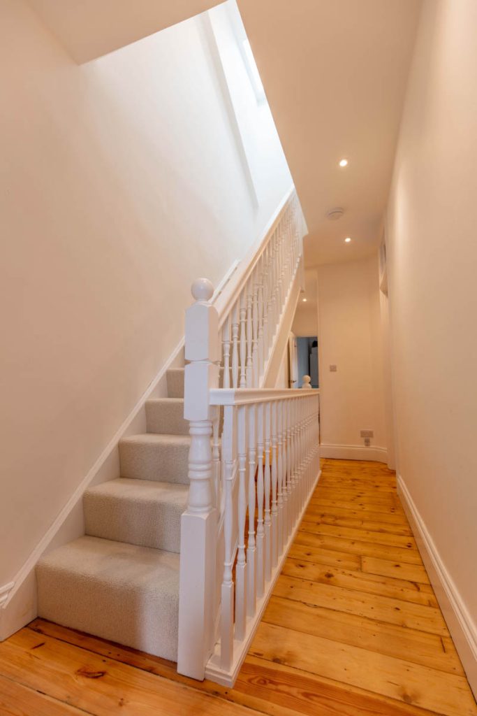 New staircase and landing lit by a rooflight in a large dormer loft conversion in Bedminster, Bristol